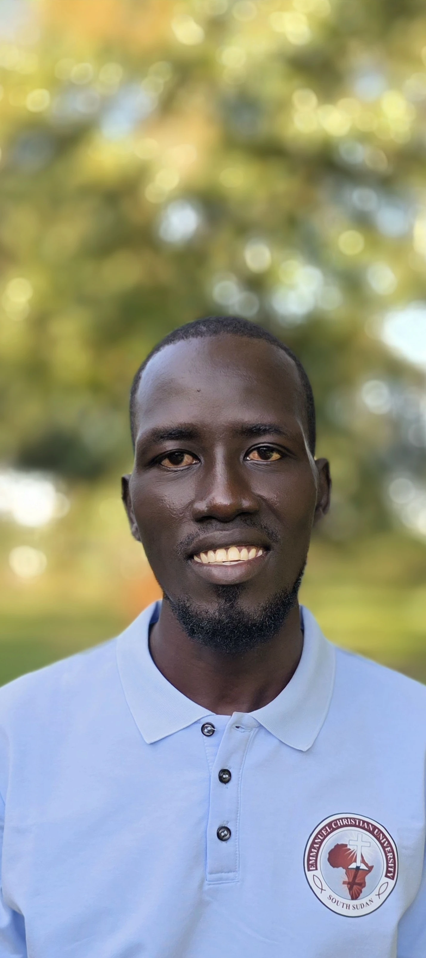 A student smiling after graduating from ECU